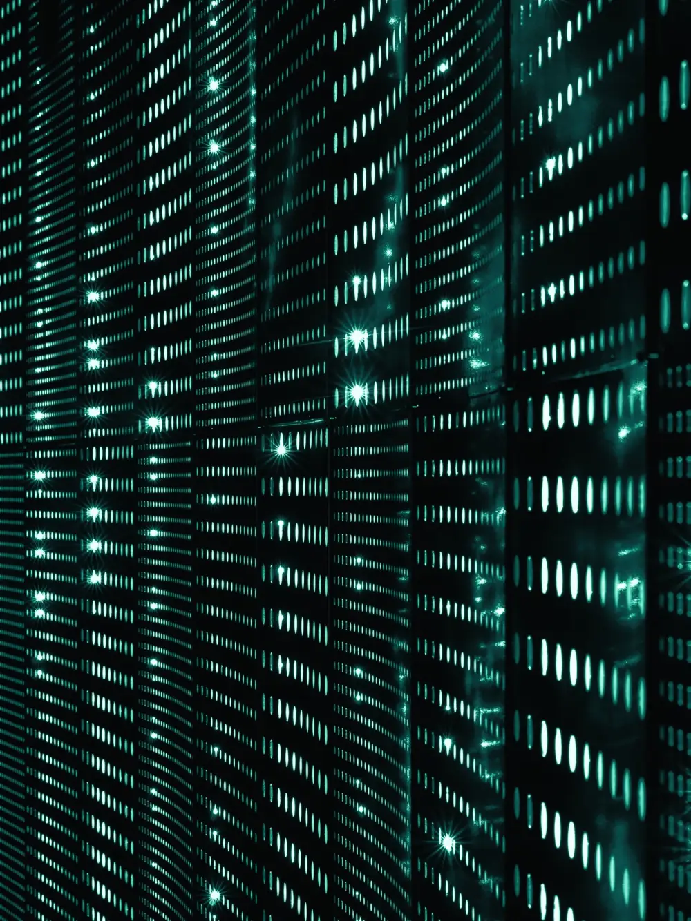 Rows of glowing server lights in a data centre